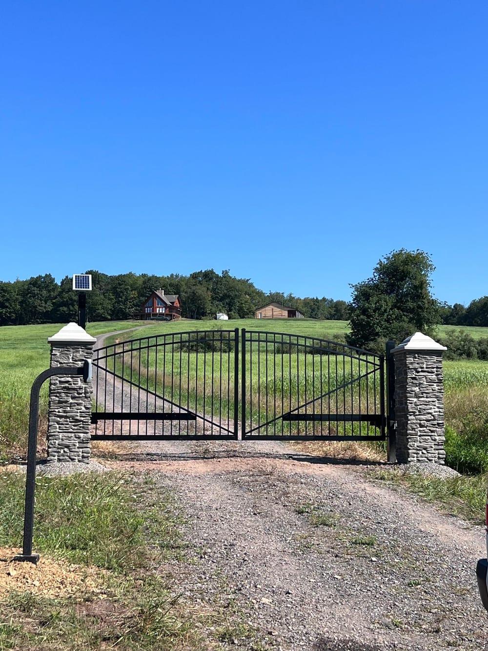 Automatic driveway gate with stone pillars